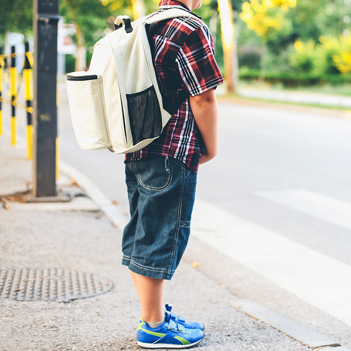 two children cross sidewalk