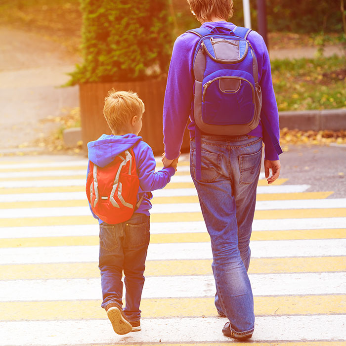 two children cross sidewalk